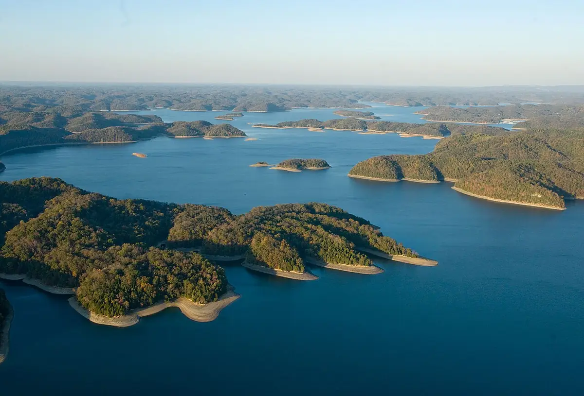 Aerial view of the wooded shorelines and blue water of Dale Hollow Lake